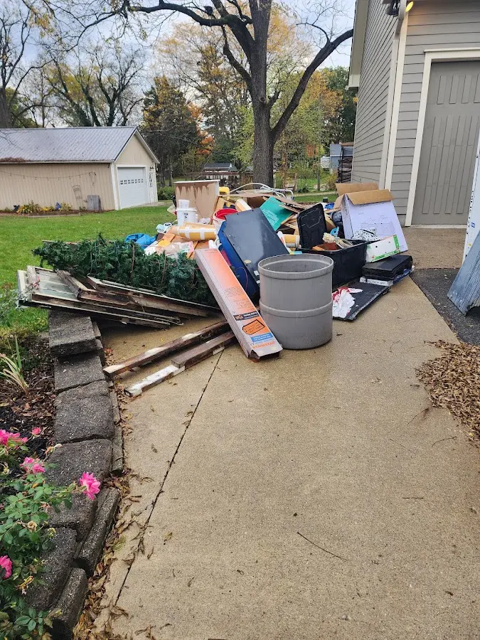 Dumpster being loaded with debris for Estate Cleanout Dumpster Rental in San Carlos